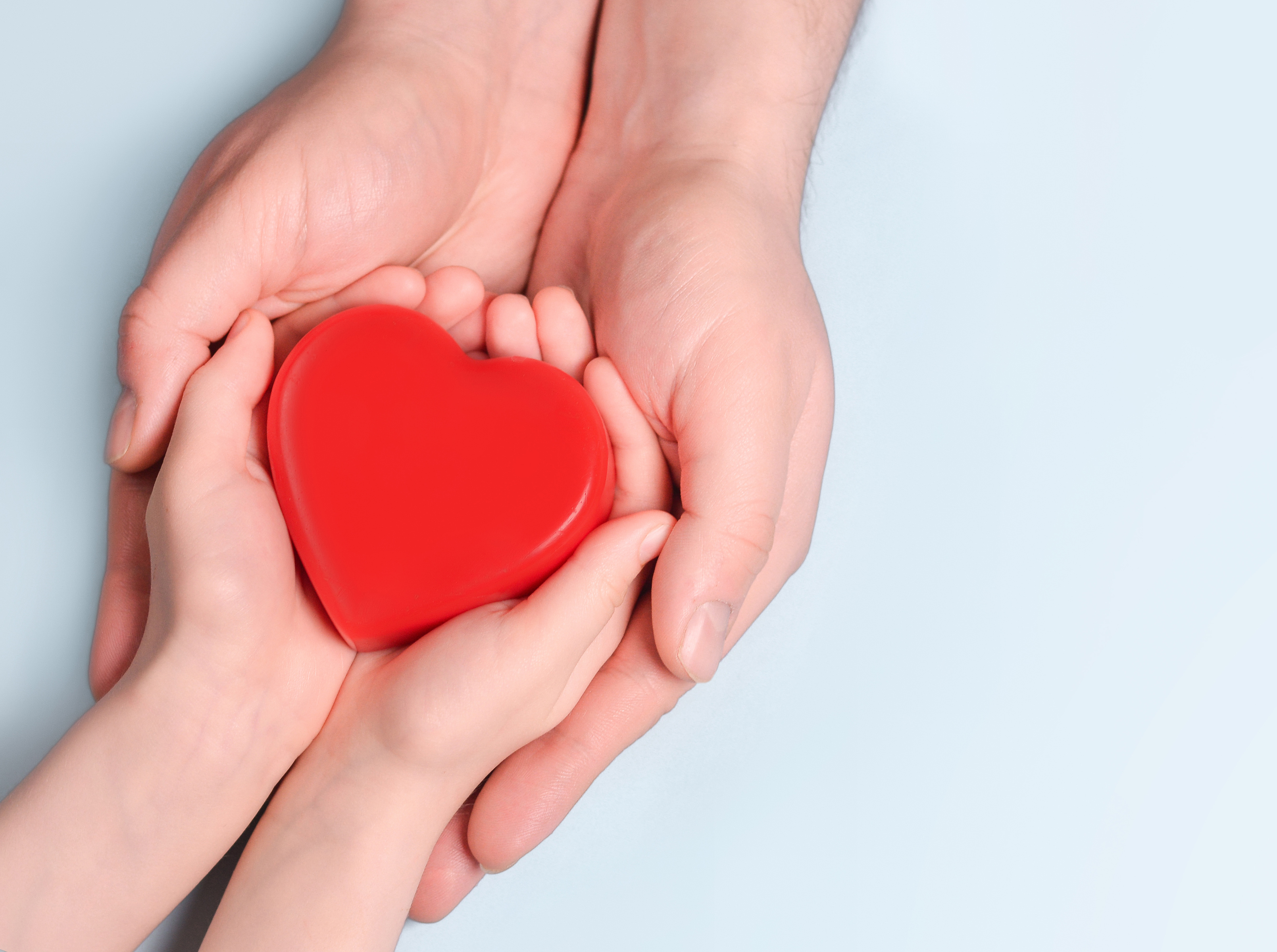 Man give red heart to kid as couple. Healthcare and hospital medical concept. Symbolic of Valentine day.Top view with space for text.